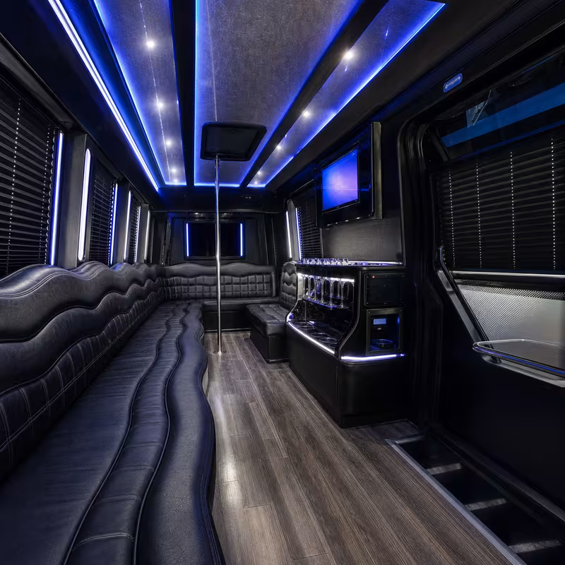 Party bus interior with wraparound leather seating and LED lighting in Lexington