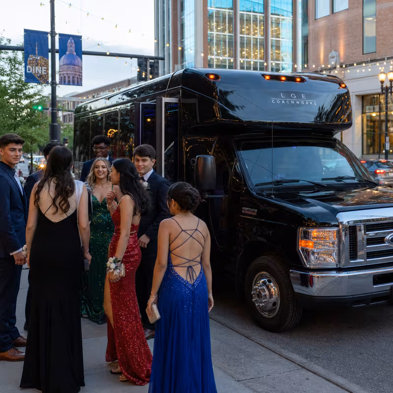 Passengers loading luggage while boarding an Lexington group shuttle