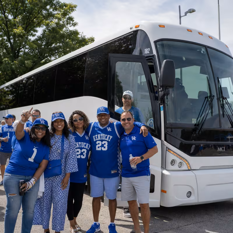 Passengers loading luggage while boarding an Lexington group shuttle