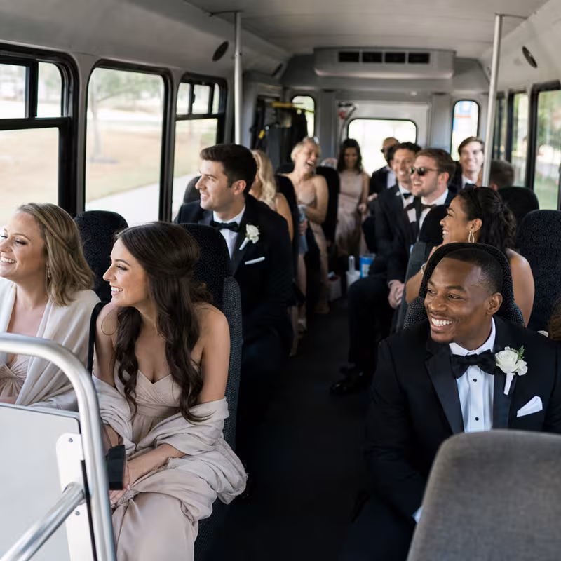 Group boarding a white charter bus for Wedding Transportation transportation in Lexington