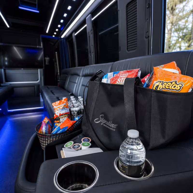 Party bus interior with wraparound leather seating and LED lighting in Lexington